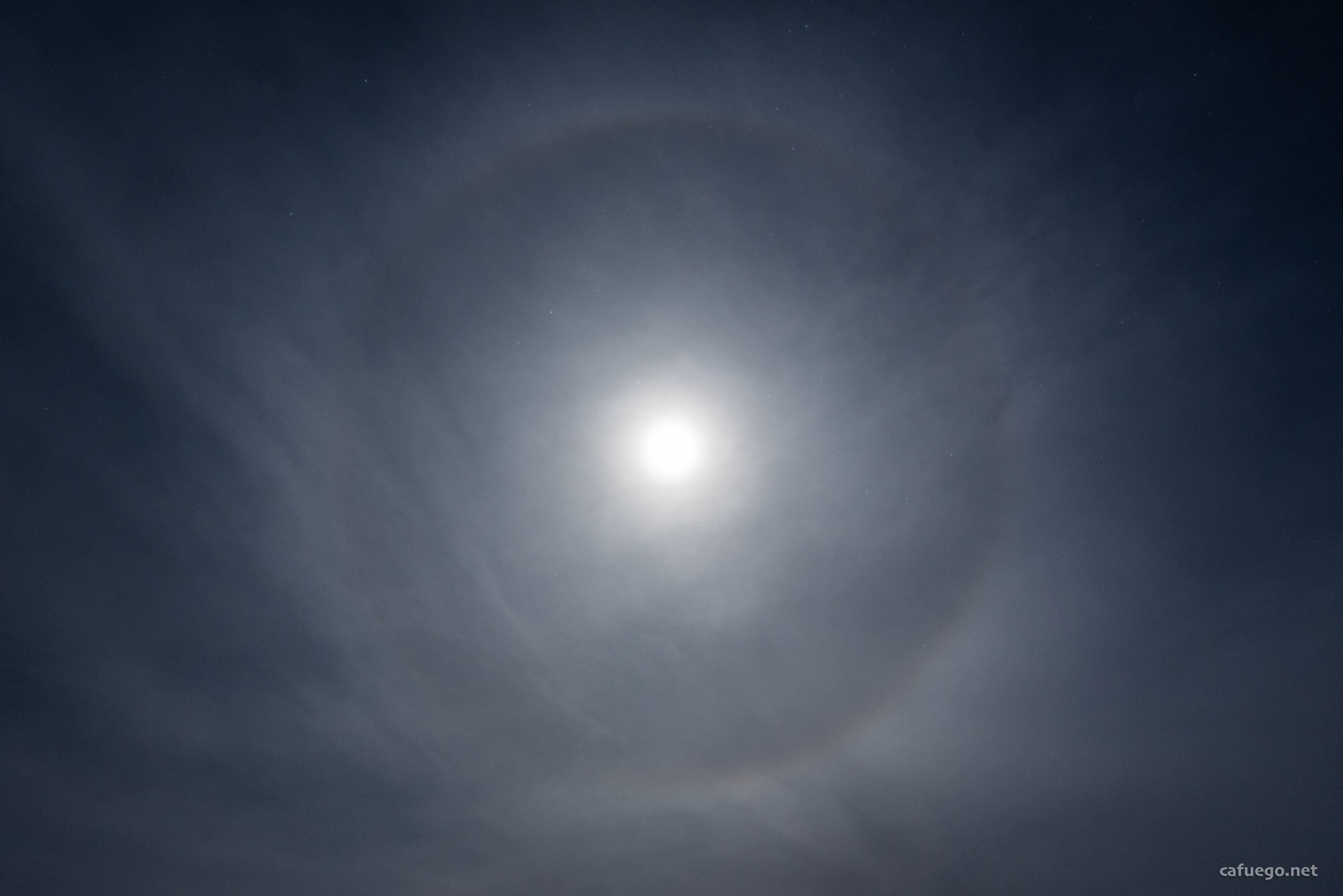 A very bright over-exposed Moon, surrounded by a halo. Some wispy thin cloud is visible and - if you check carefully - you can just see Antares and the claws of the scorpion to the top left of the Moon and the tail and stinger on the right.